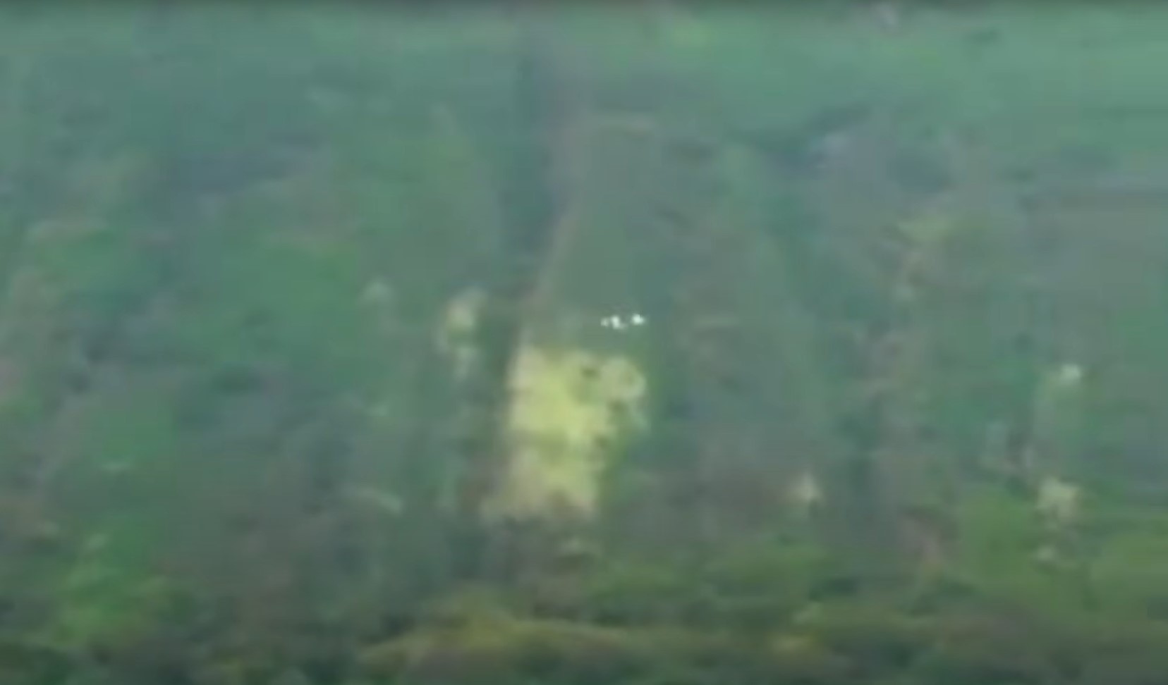 The craft appeared from behind a hillside and looked as if it was spinning while it traveled over the land