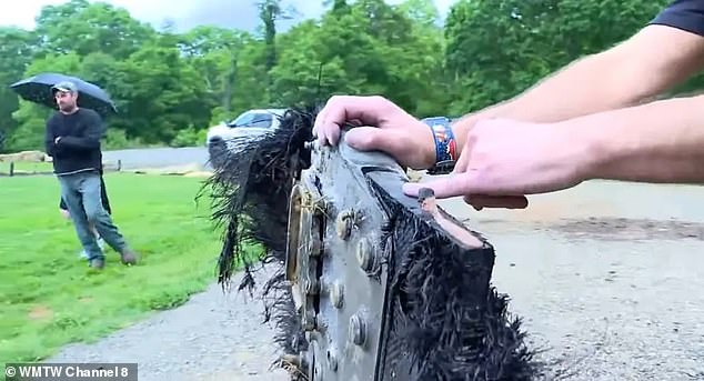 Above, more detail from the futuristic SpaceX trunk panel, fuzzed with burnt and frayed carbon fibers, bolted between heavy metal plates