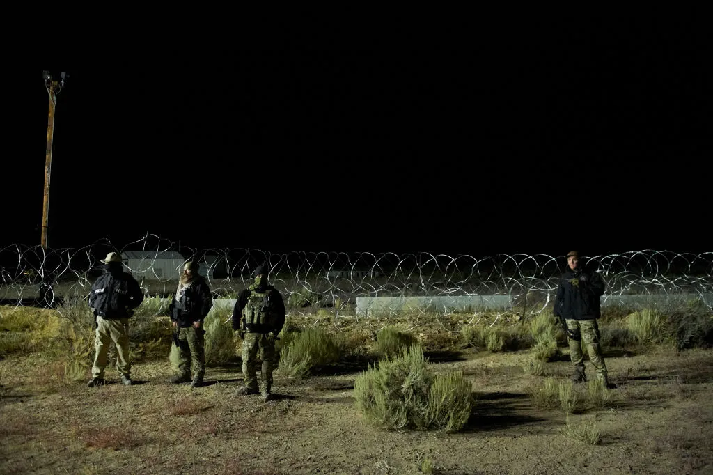 Law enforcement stand near barb wire, as people gathered to 'storm Area 51' near Rachel, Nevada, USA on 20 September 2019. Photo by Bridget BENNETT / AFP) (Photo credit should read BRIDGET BENNETT/AFP via Getty Images