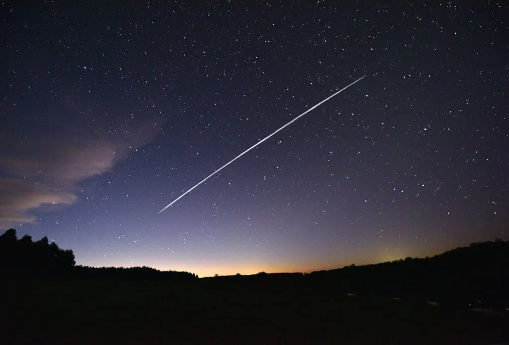 A group of SpaceX Starlink satellites in the night sky over Uruguay. Photo by Mariana SUAREZ / AFP via Getty Images