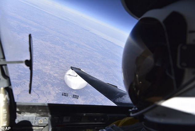 Above, a US Air Force pilot looks down at the first, alleged Chinese spy balloon as it glided over Montana on February 3, 2023. Unlike the smaller UFOs shot down later that month, this device was massive - its balloon was reportedly bigger than Disney's geodesic sphere at Epcot Center