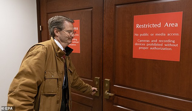 The new whistleblower report is said to have originated as a document delivered to select members of Congress. Congressman Tim Burchett steps into a 'Sensitive Compartmented Information Facility' or SCIF (above) for a prior classified UFO briefing held on Capitol Hill