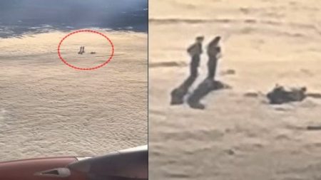 Airline passenger captures two figures appearing to stand on a cloud layer
