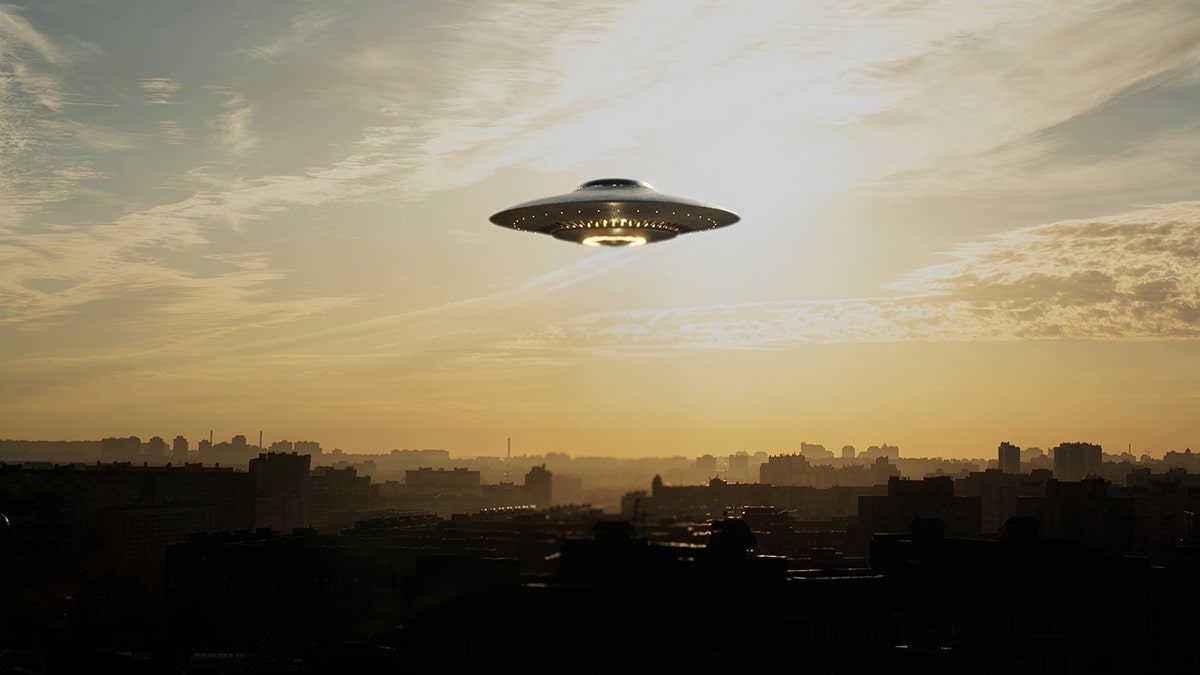 An alien spaceship in the sky over a city